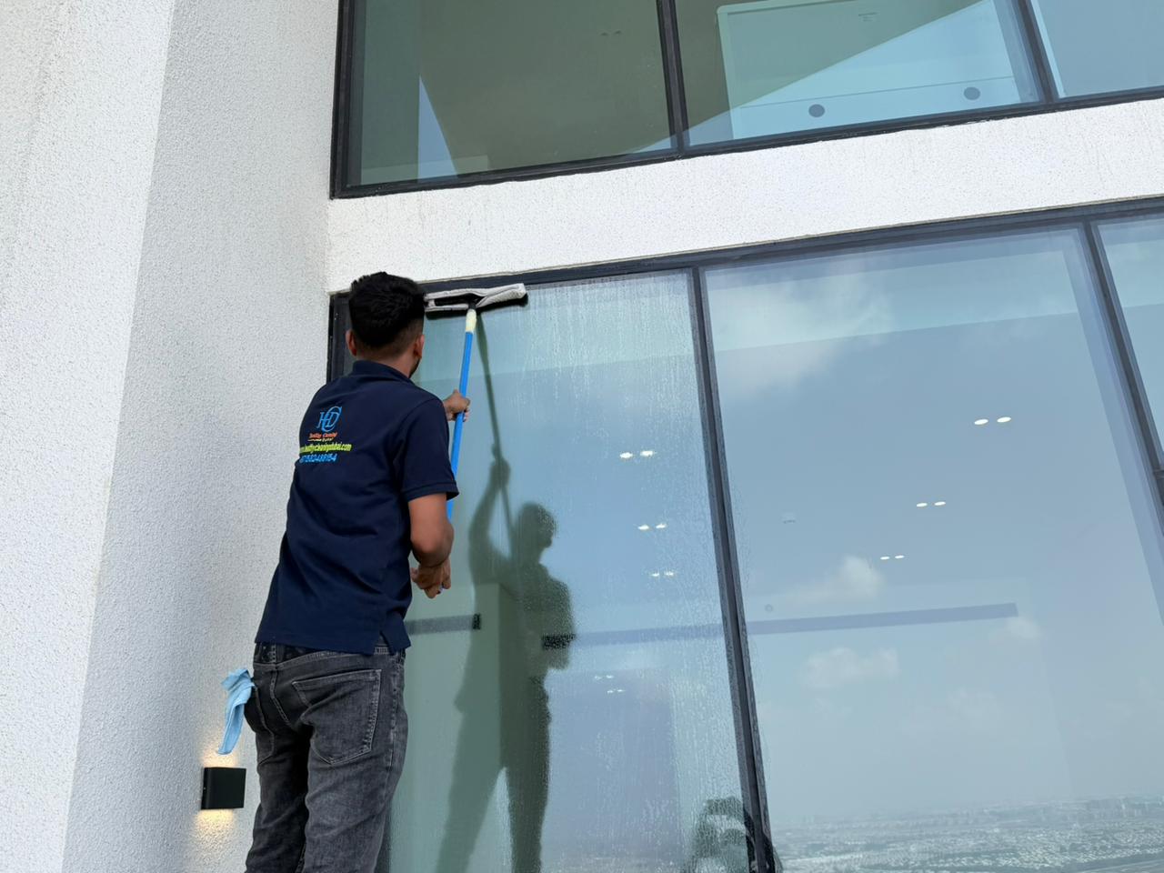 Two professional cleaners smiling in a bright modern home