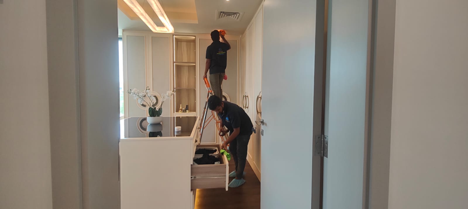 Cleaner disinfecting a modern office desk