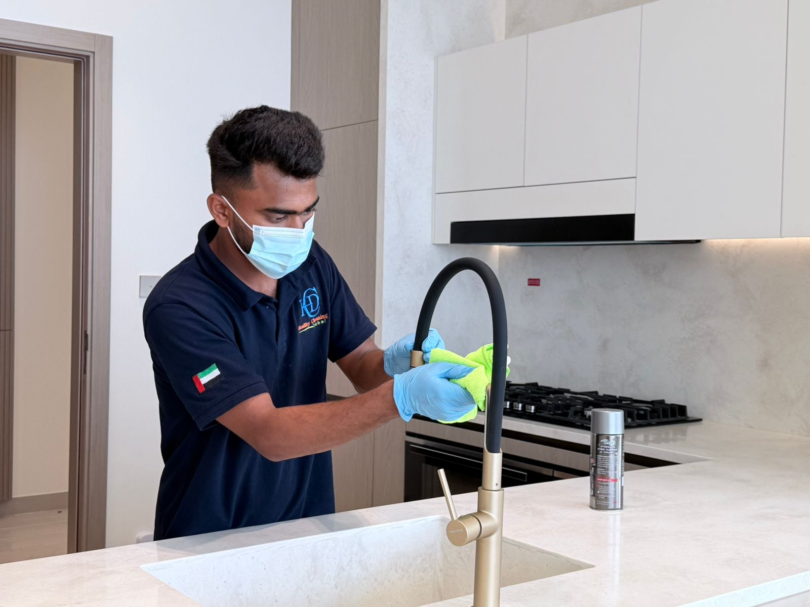 Cleaner mopping a sparkling clean modern kitchen